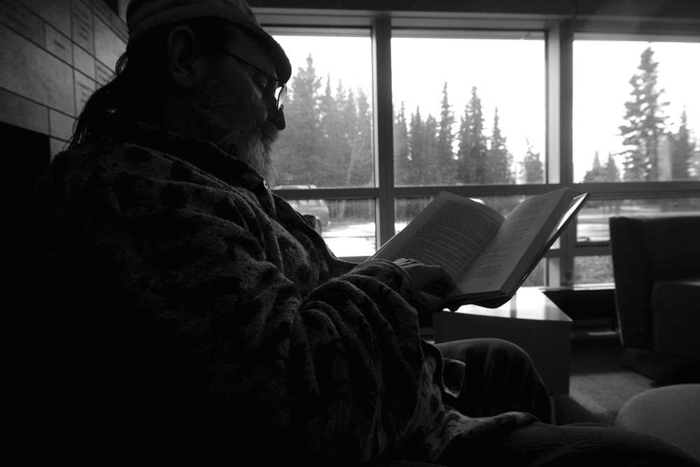 Photo by Rashah McChesney/Peninsula Clarion  Larry Hull reads an autobiography on Sammy Davis Junior on Wednesday April 8, 2015 at the Kenai Community Library in Kenai, Alaska.