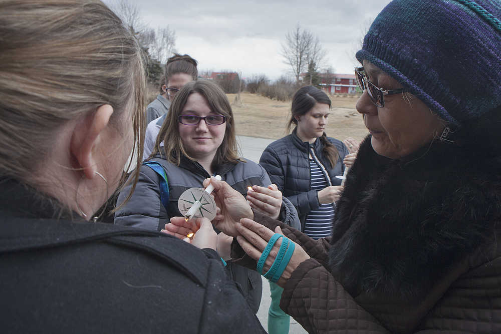 Photo by Rashah McChesney/Peninsula Clarion  Several women gathered to light white candles on Thursday April 9, 2015 during a vigil to honor victims of sexual assault at the Tyotka's Elder Center in the Fort Kenay building in Kenai, Alaska. The Kenaitze Indian Tribe domestic violence and sexual assault prevention program organizers talked about the services they offered to the community during the vigil.