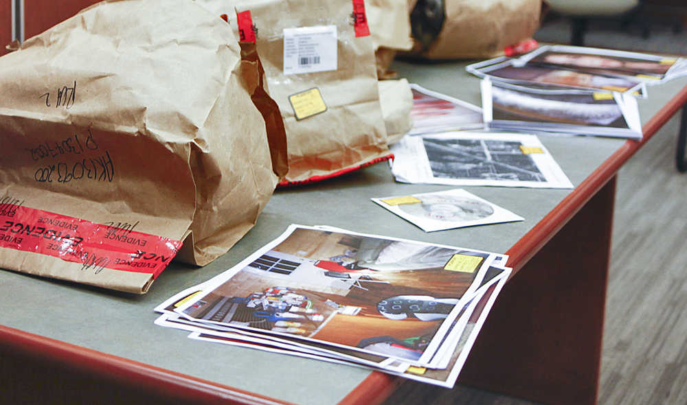 Photo by Rashah McChesney/Peninsula Clarion Evidence bags and photographs pile up on an exhibit table during the attempted rape, burglary and assault trial against Soldotna man Shane Heiman, on Wednesday April 15, 2015 in Kenai, Alaska.