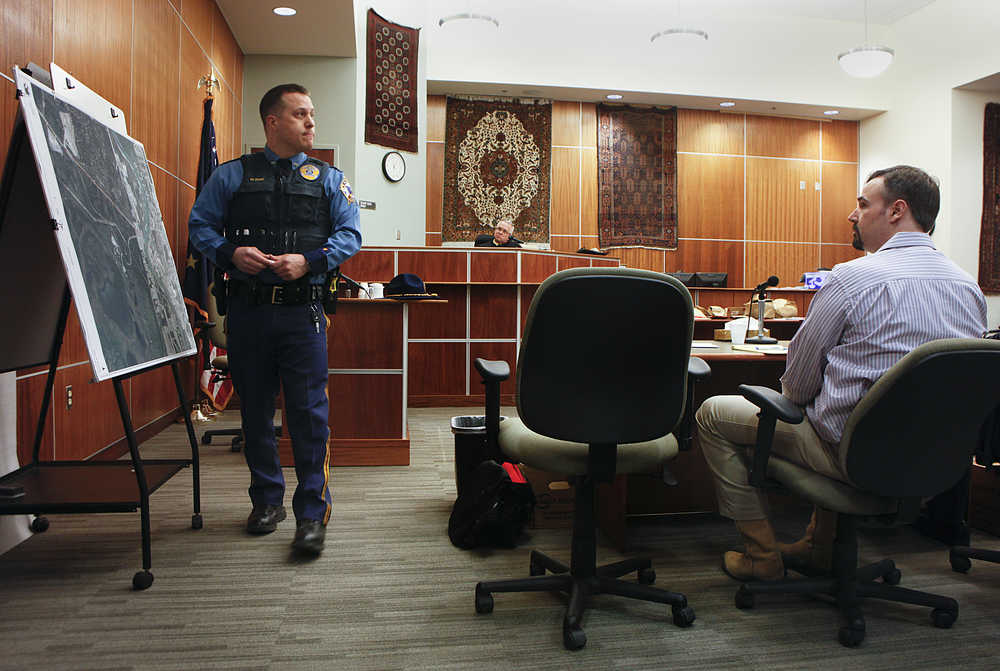 Photo by Rashah McChesney/Peninsula Clarion  Alaska State Trooper Matt Ezell circles several areas on a map of Soldotna where he searched for footprints as evidence to corroborate a story of kidnapping and rape levied against Shane Heiman (right) during Heiman's trial for a separate attempted rape on Thursday, April 16, 2015 in Kenai, Alaska. The prosecution and defense rested and closing arguments will be heard Friday before the jury goes into deliberations.
