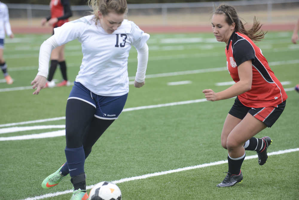 Photo by Kelly Sullivan/ Peninsula Clarion Soldotna High School's Miranda Wolfe gets rid of the ball before Kenai High School's Heidi Perkins steal it Friday, April 17, 2015, at Kenai Central High School in Kenai, Alaska.