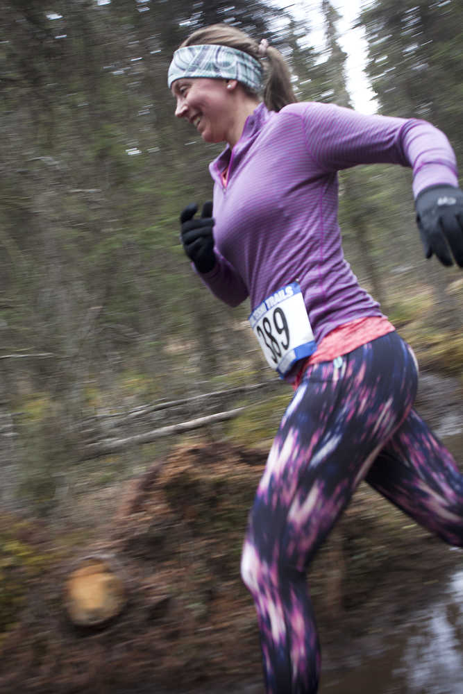 Photo by Rashah McChesney/Peninsula Clarion Aurora Agle (CHECK THIS!!) jumps over a muddy spot during the Choose Your Weapon race on the Tsalteshi Trails Saturday April 18, 2015 in Soldotna, Alaska.