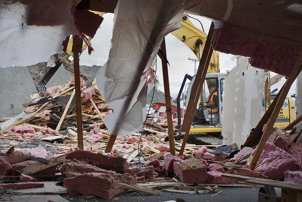 Photo by Rashah McChesney/Peninsula Clarion Ron Robertson, of S&R Enterprises demolishes a portion of the Kenaitze Indian Tribe's Tyotka's Elder Center building at the corner of Mission Avenue and Upland Drive on Monday April 20, 2015 in  Kenai, Alaska. The tribe is currently accepting bids for the construction of a new elders building to be constructed this summer on the same plot of land. Tyotka's provides meals, healthy activities and advocacy to elders.