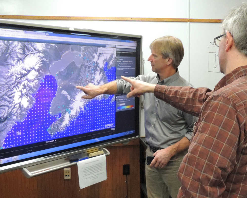 Lynda Giguere/Cook Inlet Regional Citizens Advisory Council Tesoro personnel Peter Ribbens (left) and Marc Johnson (right) use the Cook Inlet Response Tool to plan an oil spill drill during a training in March 2014 at the Cook Inlet Spill Response and Prevention, Inc headquarters in Kenai.