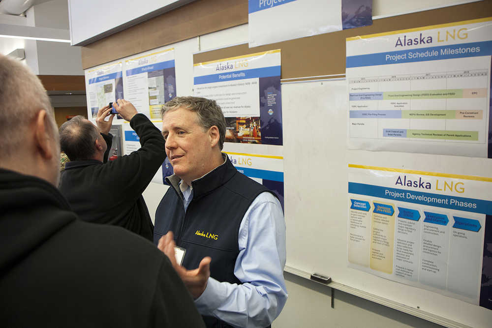 Photo by Rashah McChesney/Peninsula Clarion Michael Nelson, socioeconomic lead for the Alaska LNG project, talks to a group of community members during an open house on Thursday April 23, 2015 at the Nikiski Community Recreation Center in Nikiski, Alaska. More than 150 people attended the project meeting to learn about changes and the feasibility studies planned for 2015.