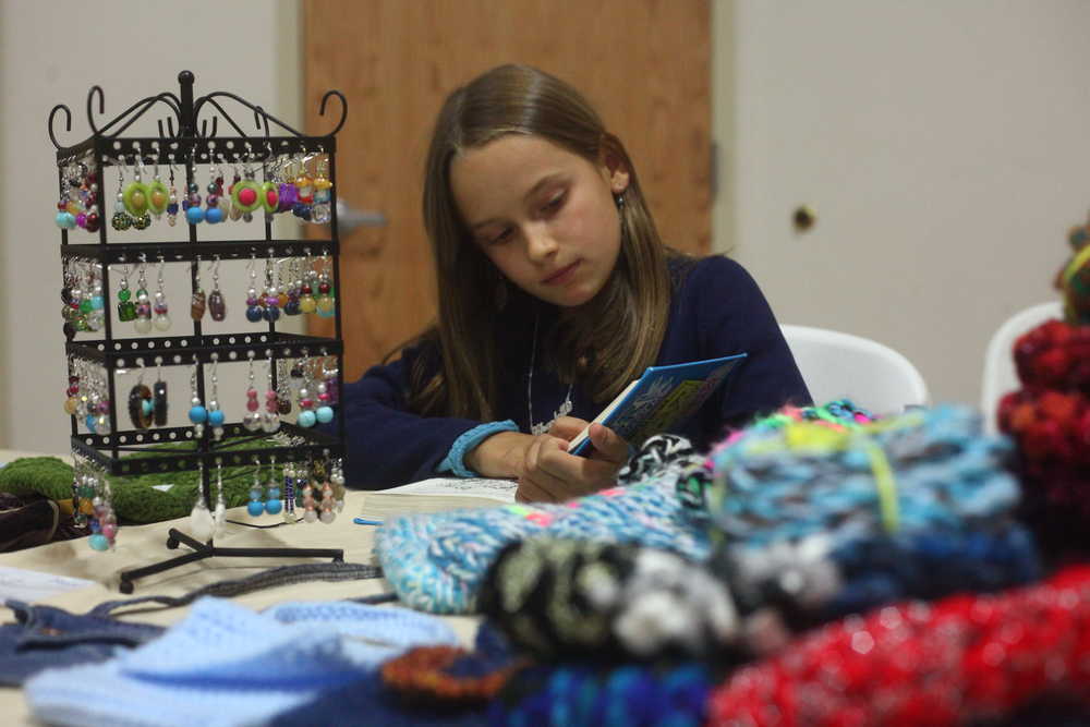 Photo by Kelly Sullivan/ Peninsula Clarion Bonnie Cain hold open one of her handcrafted cards Saturday, April 25, 2015 at the Sterling Community Center in Sterling, Alaska. "I love this. I love it with all my heart," Cain said. "I would rather make cards than eat."