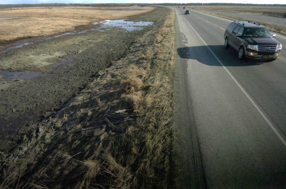 Ben Boettger/Peninsula Clarion Green material containing seed, moisture, and cotton fiber lies in the former construction area alongside Bridge Access Road on Tuesday April 28 in Kenai.