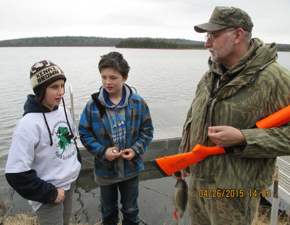 Working with two camp participants, Robert Begich (Alaska Department of Fish & Game) steps through a real-life scenario of checking waterfowl hunters on Headquarters Lake. (Photo courtesy Kenai National Wildlife Refuge)