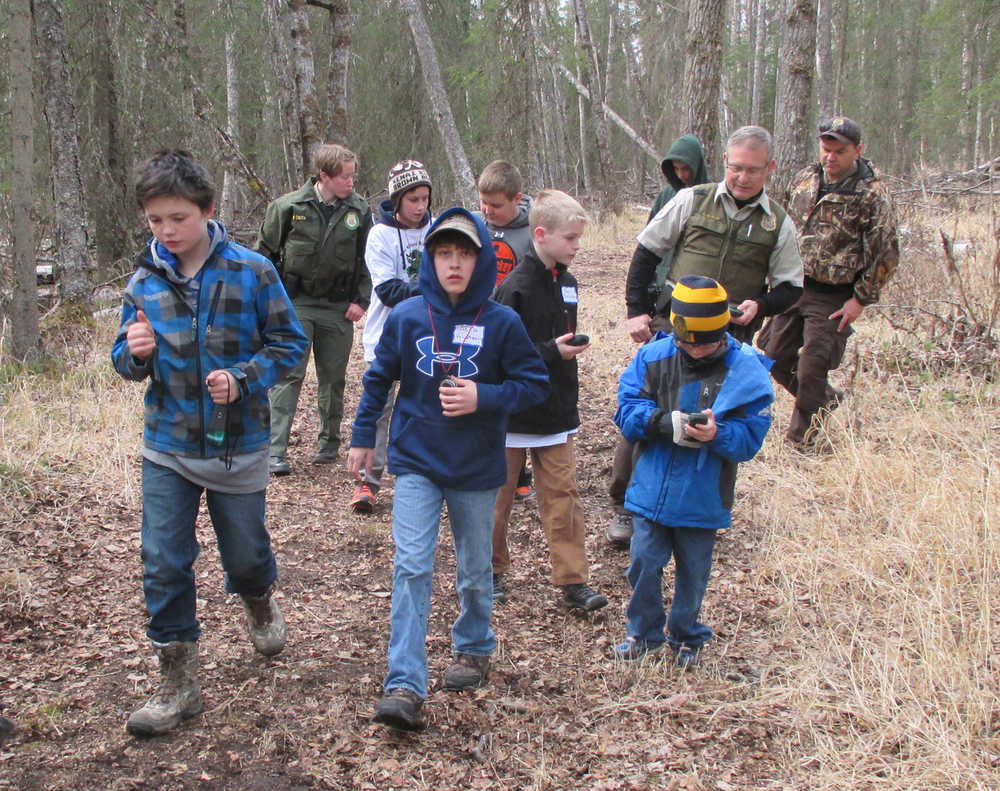 Participants in the 2015 Youth Game Warden Camp learn to navigate in the woods with GPS units and compasses. (Photo courtesy Kenai National Wildlife Refuge)