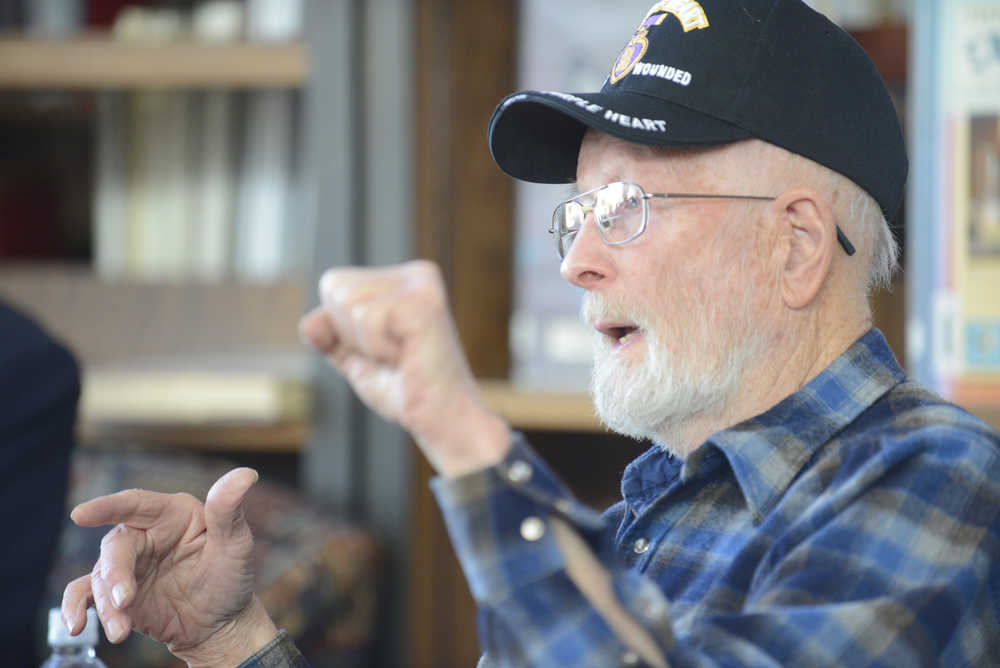 Photo by Kelly Sullivan/ Peninsula Clarion Raymon Machen-Gray listens to a story from Korean War veteran Jack Dean Thursday, April 30, 2015, at Kenai Central High School in Kenai, Alaska.