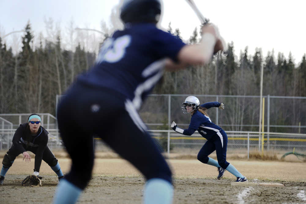 Ben Boettger/Peninsula Clarion Soldotna girls softball player Jazi Larrow prepares to steal second from Chugiak first baseman Alise Arnold, with Renee Hinz at bat during a game on Friday May 1 in Soldotna.
