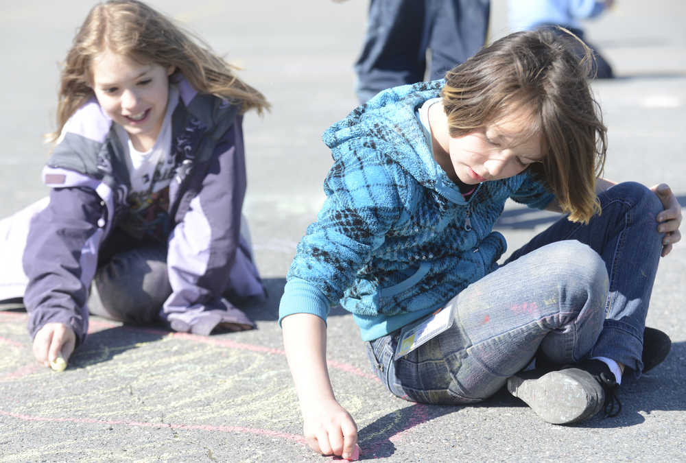 Photo by Kelly Sullivan/ Peninsula Clarion Angel Anderson finishes up the giant rose she made with chalk at the Kenai Boys and Girls Club Kenai Clubhouse Monday, May, 4, 2015, in Kenai Alaska. Her friend Cadie Fabiano stopped for a moment to help draw. The girls said they were enjoying the warm weather.