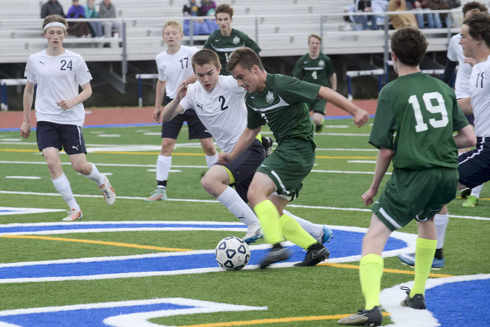 Photo by Rashah McChesney/Peninsula Clarion  Soldotna's Thomas Flores goes head to head with a Colony player during their game on Friday May 8, 2015 in Soldotna, Alaska.