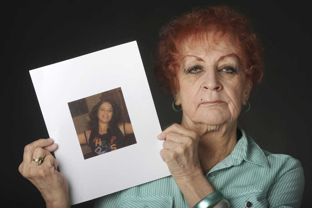 ADVANCE FOR SUNDAY MAY 10, 2015 AND THEREAFTER- In this photo taken April 26, 2015, Judy Connolly holds a photograph in Anchorage, Alaska, that was taken just days before her 16-year-old daughter Shelley Connolly was found dead in 1978. On a foggy Saturday morning in early January 1978, the body of a 16-year-old girl was found in a ditch off the Seward Highway. An autopsy would later determine she had been beaten, sexually assaulted, dragged behind a car and then tossed down an embankment. (Bill Roth/Alaska Dispatch News via AP)