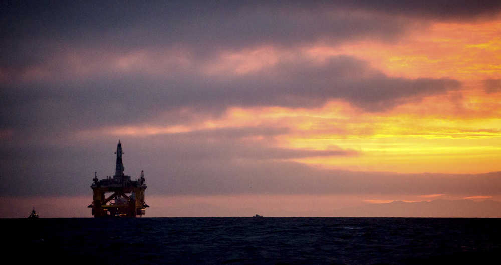 FILE - In this April 17, 2015 file photo, an oil drilling rig arrives aboard a transport ship at sunrise, following a journey across the Pacific in Port Angeles, Wash. Royal Dutch Shell hopes to use the rig for exploratory drilling during the summer open-water season in the Chukchi Sea off Alaska's northwest coast, if it can get the permits. Royal Dutch Shell cleared a major hurdle Monday, May 11, 2015, when The Bureau of Ocean Energy Management approved Shell's exploration plan. However, this isn't the final step that Shell needs for Arctic drilling. (Daniella Beccaria/seattlepi.com via AP) MAGS OUT; NO SALES; SEATTLE TIMES OUT; TV OUT; MANDATORY CREDIT