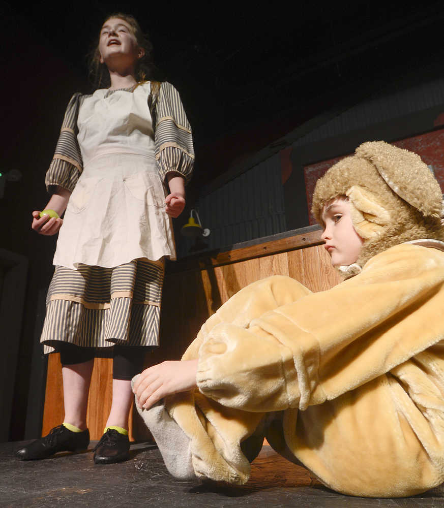 Photo by Rashah McChesney/Peninsula Clarion  Annie (Anya Hondel) and a stray dog Sandy (Kincaid Jenness) rehearse for the Triumvirate Theatre's production of the musical Annie on Tuesday Jan. 13, 2014 in Nikiski, Alaska.