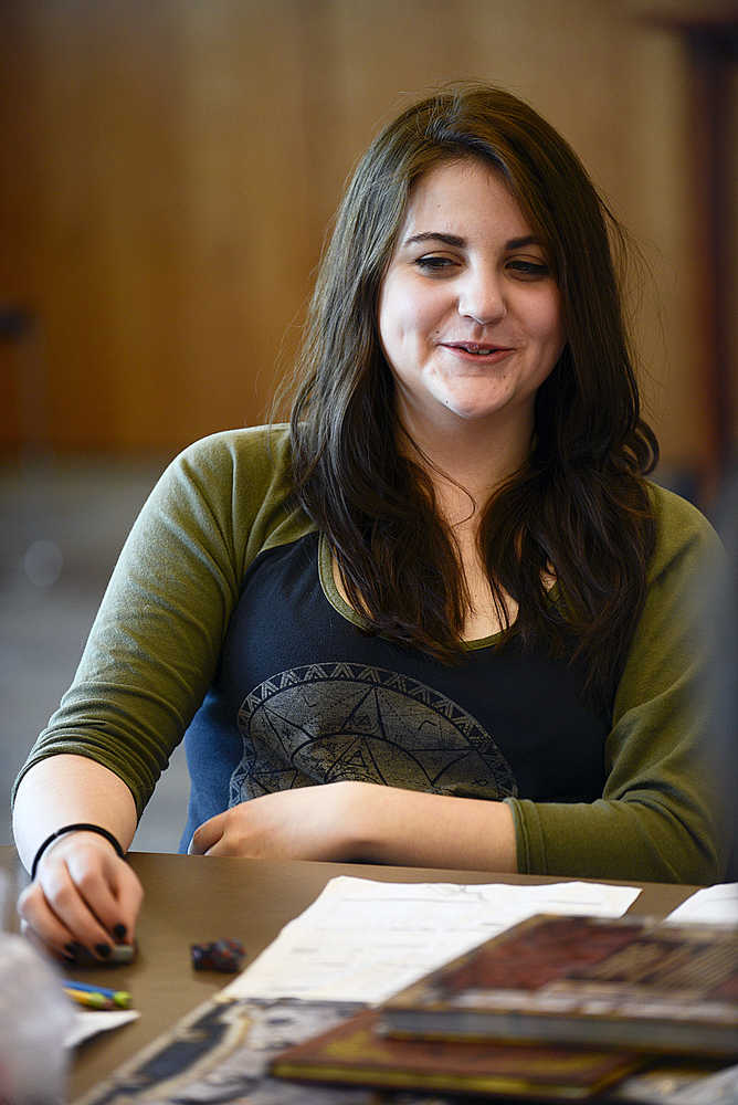 Photo by Rashah McChesney/Peninsula Clarion  Shannon Bradford laughs during a break in a Dungeons & Dragons game on April 22, 2015 in the community room at the Soldotna Library. Bradford and a handful of others play the fantasy role playing game regularly at the library and will be hosting a marathon D&D day at the library for community members interested in learning more about gameplay.