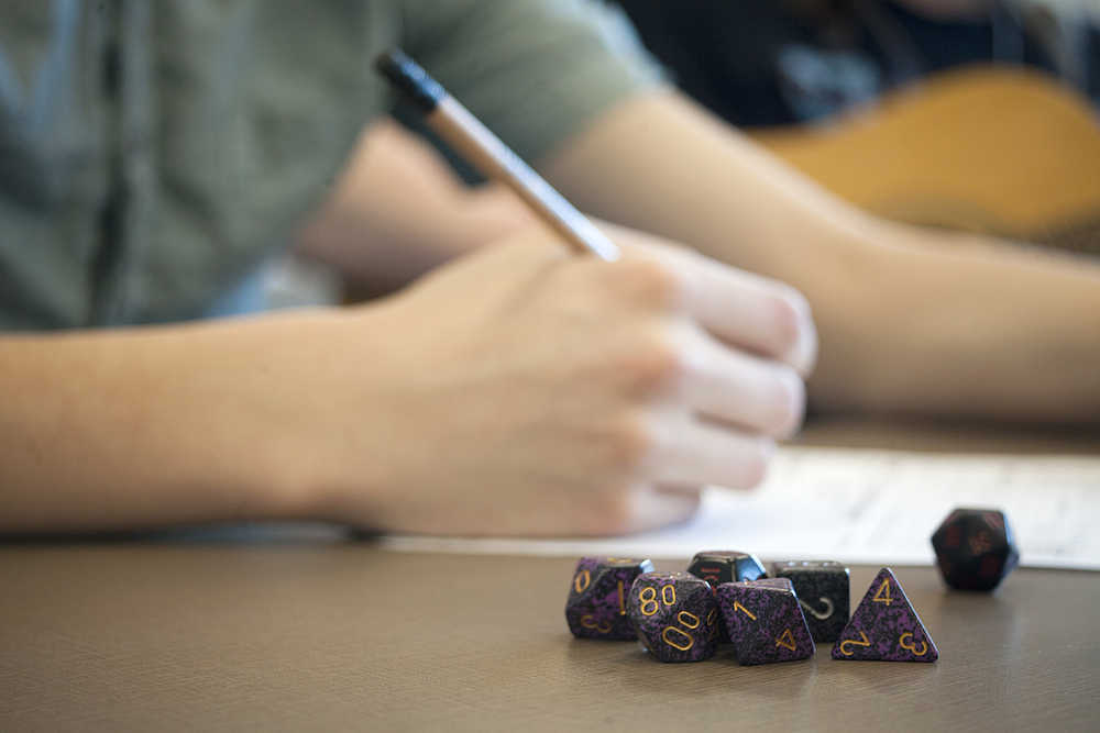Photo by Rashah McChesney/Peninsula Clarion A pile of multi-sided dice lays on the table next to a character who plays Dungeons & Dragons with a group at the Soldotna library. The group is hosting its first community-wide all-day Dungeons & Dragons game on Saturday in the community room at the library.