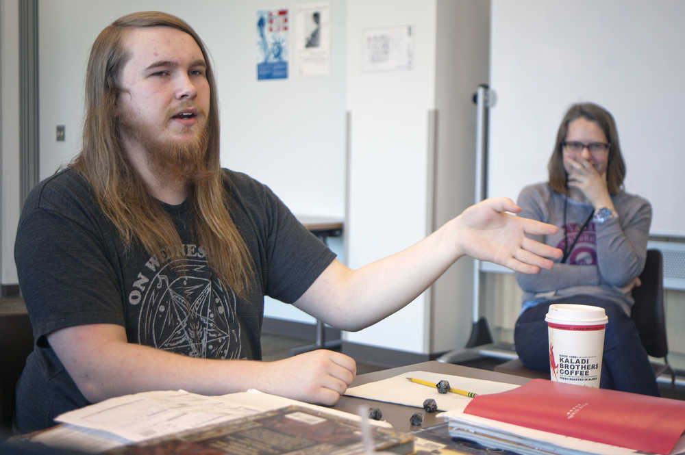 Photo by Rashah McChesney/Peninsula Clarion Johnathan Rine, dungeon master for a group who plays the fantasy role-playing game Dungeons & Dragons, explains the subtleties of character building as Soldotna Public Library Youth Service Director KJ Hillgren laughs in the background on April 22, 2015 at the library. Rine and several others in his group will host a D&D marathon day, open to the public, on Saturday from 10 a.m. to 5:30 p.m.
