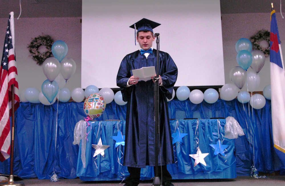 Ben Boettger/Peninsula Clarion Wings Christian Academy graduate Tyler Ophus reads his graduation speech on Friday at Immanuel Baptist Church in Kenai.