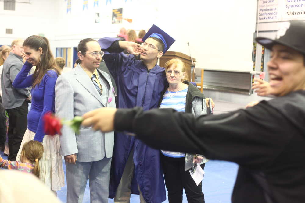 Photo by Kelly Sullivan/ Peninsula Clarion Samuel Mireles calls to a family member to join the photograph being taken after the 2015's graduating class commencement ceremony Monday, May 18, 2015, at Ninilchik School in Ninilchik, Alaska.