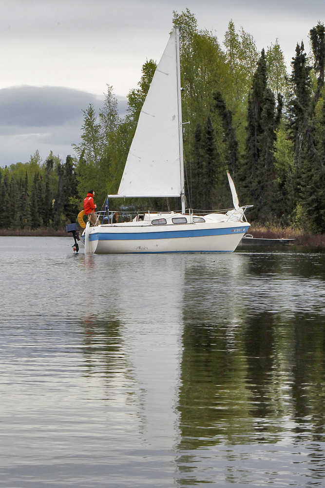 Photo by Rashah McChesney/Peninsula Clarion  Brett Vadla slowly pilots his sailboat toward a dock on Sport Lake on Tuesday May 19, 2015 near Soldotna, Alaska.