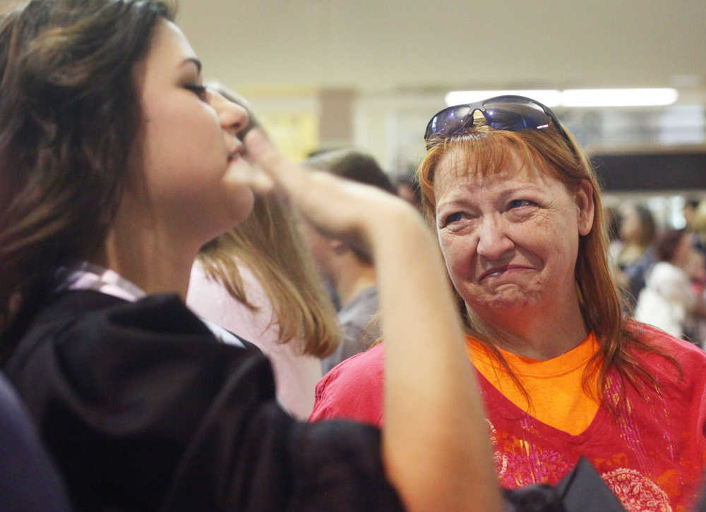Photo by Kelly Sullivan/ Peninsula Clarion Graduating senior Ben Carstens chats with friends following commencement Wednesday, May 21, 2015, in the Nikiski Middle-High School commons area in Nikiski, Alaska.