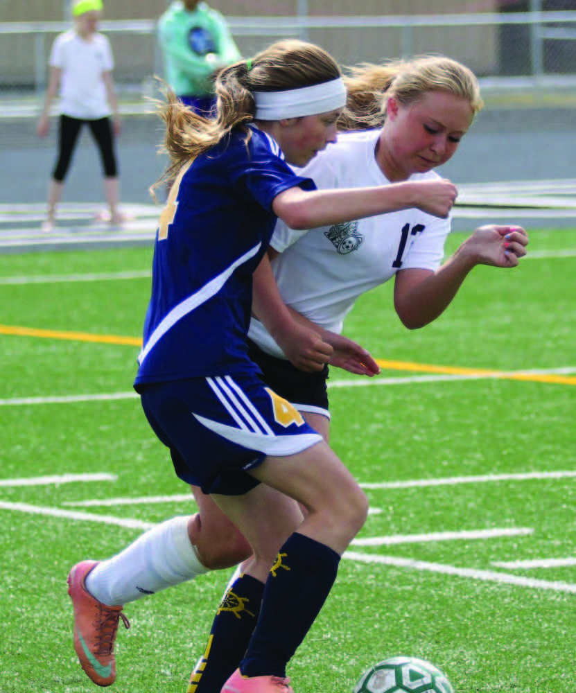 Colony junior Ripley Wakaliuk works to keep the ball away from Homer freshman Aspen Daigle during a 4-0 win over the Mariners in the Northern Lights Conference quarterfinals May 21 at Colony High School in Palmer.