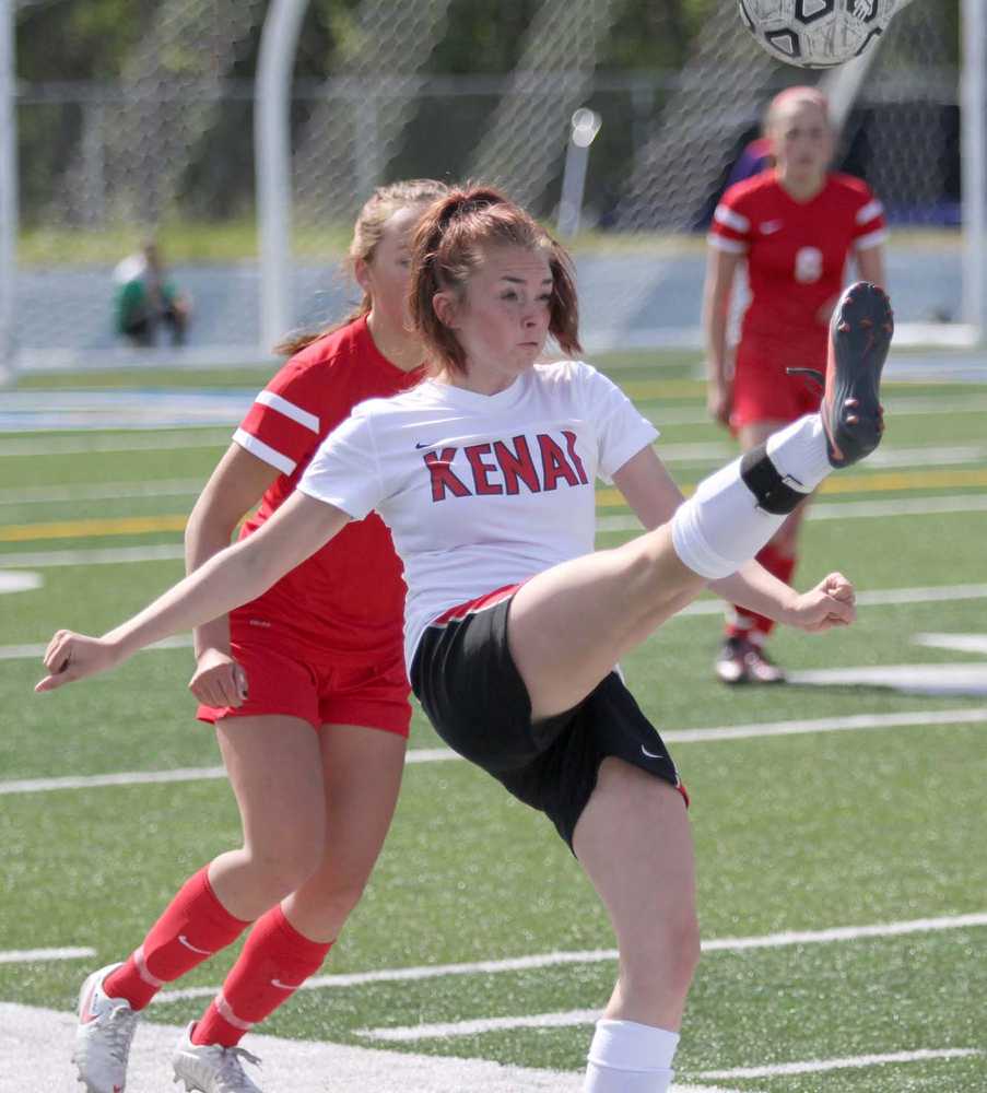 Kenai's Cori Holmes tries to volley the ball over the head of a Wasilla defender during a 2-1 overtime win over the Warriors in the Northern Lights Conference semifinals May 22 at Palmer High School.
