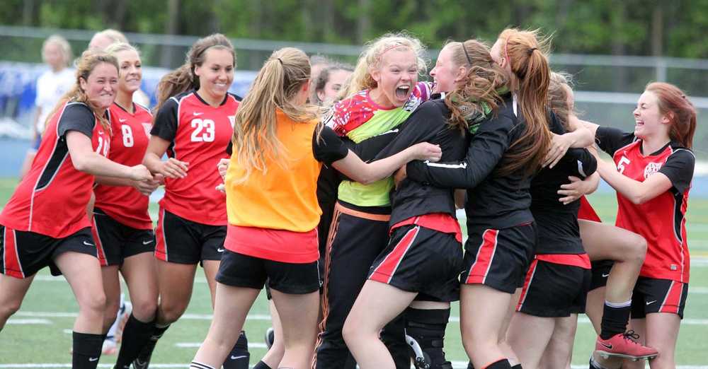The Kenai Kardinals rush to hug goalkeeper Ali Steinbeck after the Kards edged rival Soldotna 3-2 in overtime in the Northern Lights Conference girls' title game at Palmer High School May 23.