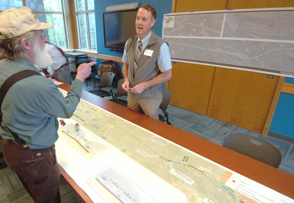 Ben Boettger/Peninsula Clarion A member of the public speaks with DOWL Engineer Steve Nobel (right) over a map of the proposed Sterling Highway improvements at a Department of Transportation/Kenai WIldlife Refuge open house on Tuesday, May 19 at the Kenai WIldlife Refuge Visitors Center.