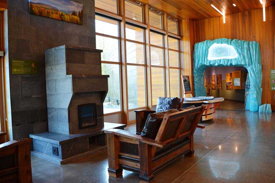 The Center's lobby overlooks the surrounding boreal forest through floor to ceiling windows. The masonry heater's hearth is a welcome place to sit and relax all year-round. (Photo courtesy Kenai National Wildlife Refuge)