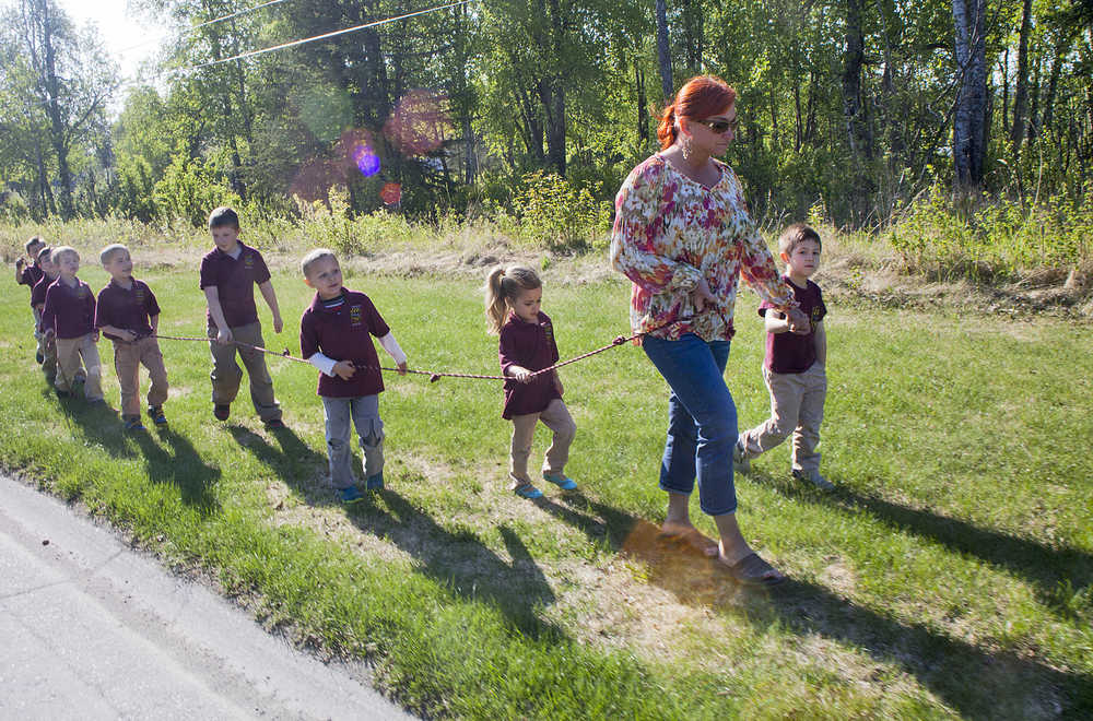 Photo by Rashah McChesney/Peninsula Clarion  A group from The Study takes a walk along Riverview Avenue on May 28, 2015 in Soldotna, Alaska.