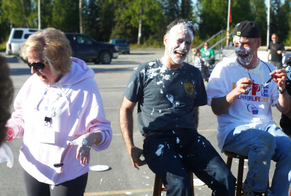 Photo by Kelly Sullivan/ Peninsula Clarion Alyson Stogsdill, a breast cancer survivor and Kenai Legislative Information Officer, hits Sen. Peter Micciche, R-Soldotna, with a pie during the 2015 Relay For Life Friday, May 29, 2015, at the Soldotna Regional Sports Complex in Soldotna, Alaska.