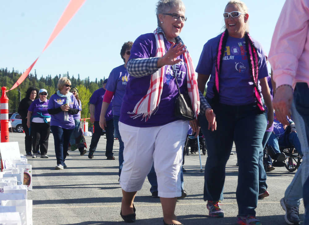 Photo by Kelly Sullivan/ Peninsula Clarion Kenai Mayor Pat Porter and Soldotna City Council member Meggean Bos walk together during the 2015 Relay For Life opening lap for survivors of cancer Friday, May 29, 2015, at the Soldotna Regional Sports Complex in Soldotna, Alaska.