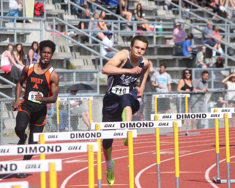 Soldotna senior Tim Duke (center) clears a hurdle en route to winning the 4A boys 300-meter hurdle race, Saturday at the Alaska state high school track and field championships in Anchorage.