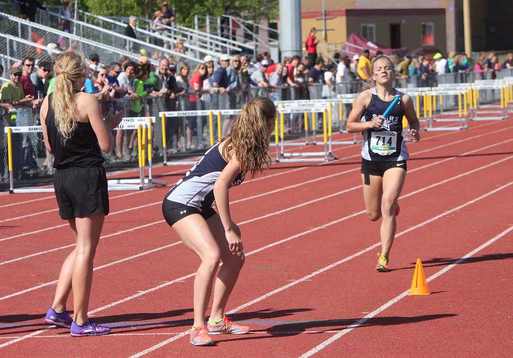 Soldotna senior Sadie Fox (714) finishes up her leg of the girls 3,200-meter relay before handing the baton off to senior teammate Dani McCormick, Saturday at the Alaska state high school track and field championships in Anchorage. The Stars claimed victory and set a new state record in the race.