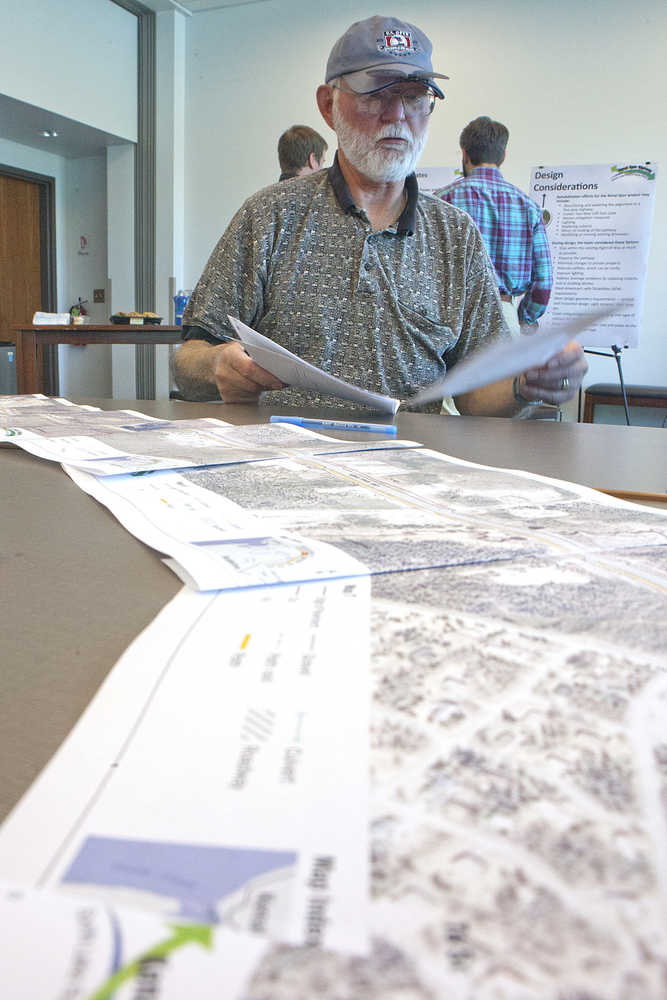 Photo by Rashah McChesney/Peninsula Clarion  Cliff Heus, of Kenai, prepares to leave written feedback for Alaska Department of Transportation project organizers on May 28, 2015 during a public meeting on the Kenai Spur Highway Rehabilitation Project in Soldotna, Alaska. Heus said he was primarily concerned with the highway's intersection with Strawberry Road - which he said was confusing and needed to be better aligned.