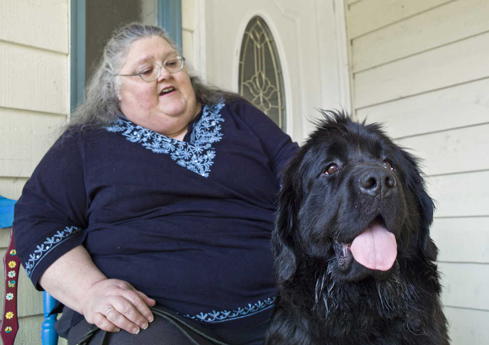 Kim Haskell watches over Kenzie, a 2-year-old Newfoundland, that she hoped would make a good service dog for her.