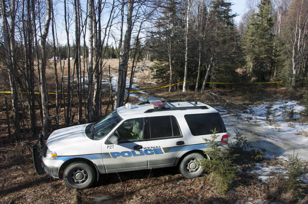 Photo by Rashah McChesney/Peninsula Clarion Investigators set up a temporary facility between Alpine Drive and Borgen Avenue on Sunday March 22, 2015 after finding the remains of what Kenai Police believe to be a family that has been missing for nearly 10 months from their Kenai.