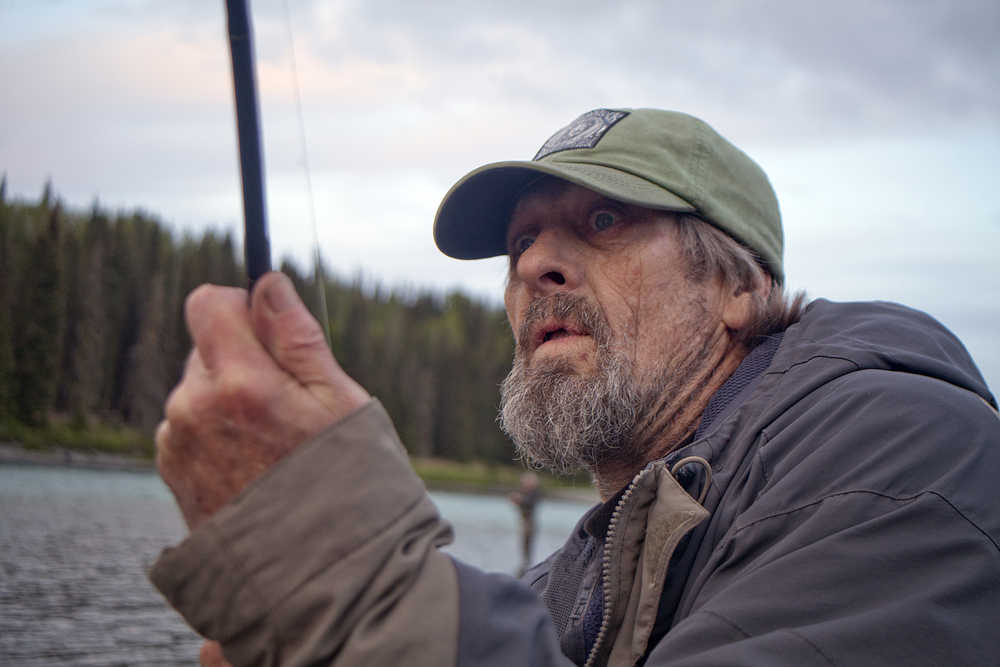 Photo by Rashah McChesney/Peninsula Clarion  Mike Matheny, of Kasilof, reacts after a 20-pound king salmon surprised him by hooking itself on his line as he fished on the Kasilof River after catching it on Tuesday June 2, 2015 near Crooked Creek in Kasilof, Alaska.