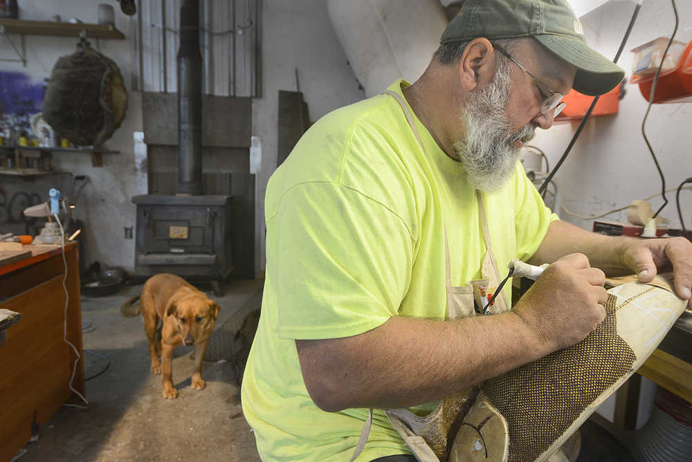 Photo by Rashah McChesney/Peninsula Clarion  Greg Landeis, owner of Black Spruce Studios, talks about a heart-shaped wooden frame that he is designing for a client's wedding on Saturday May 6, 2015 in Sterling, Alaska. Landeis carved the heart shape out of the wood and into smaller pieces that can be signed by wedding guests before being set back into the frame and affixed permanently into the piece.