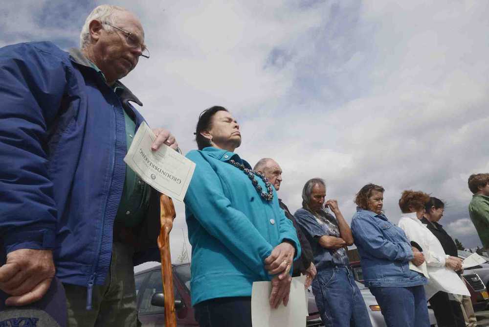 Photo by Kelly Sullivan/ Peninsula Clarion Bill and Judy Oyler participate in the blessing given at the Kenaitze Indian Tribe's Tyotkas Elder Center groundbreaking Monday, June 8, 2015, in Kenai, Alaska. The new building will be 6,500 square feet, 1,500 square feet bigger than the old center. Before the Kenaitze Indian Tribe purchased the building more than ten years ago, it had been used as a general store, restaurant and pharmacy, said the tribe's Executive Director Jaylene Peterson-Nyren. The new center is within walking distance of the Dena'ina Wellness Center and is designed by Kahtnuht'ana Development Corp., a new corporation whose sole shareholder is the tribe, Peterson-Nyren said.