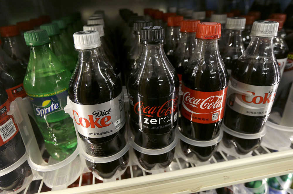 FILE - This Wednesday, Oct. 1, 2014, file photo, shows soft drinks for sale at K & D Market in San Francisco. San Francisco officials are deciding whether to impose a warning on ads for soda pop. Supporters and opponents say San Francisco would be the first place in the country to require warnings on ads for soda, which is linked to rotting teeth and obesity. (AP Photo/Jeff Chiu, File)
