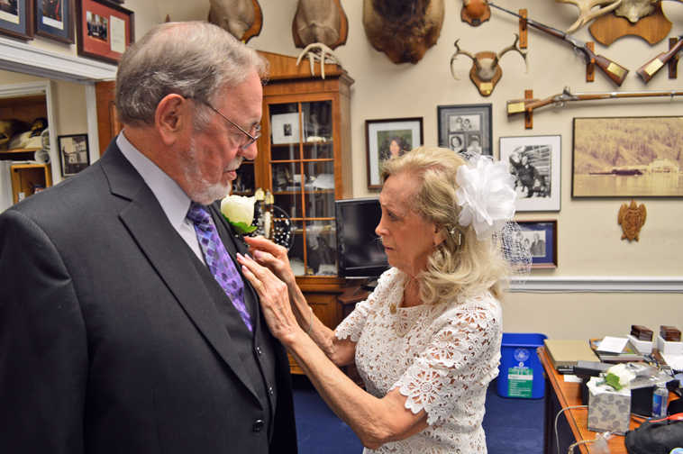 In this image provided by Rep. Don Young's Press Secretary Matthew Shuckerow, Anne Garland Walton, right, pins a flower on the lapel of Young just before they were married Tuesday. Young, the longest-serving Republican in the U.S. House, married Walton during a private ceremony Tuesday in the chapel of the U.S. Capitol. (Matthew Shuckerow/Congressman Don Young's Office via AP)