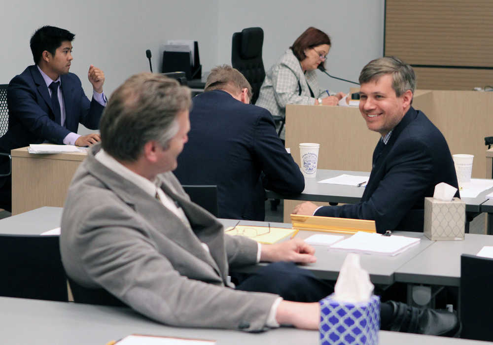 Alaska State Senator Bill Wielechowski, D-Anchorage, right, speaks to Sen. Mike Dunleavey, R-Wasilla, during a break in the special session of the Alaska Legislature on Thursday, June 11, 2015, in Anchorage, Alaska. The Senate and House on Thursday approved a compromise $5 billion state budget.  (AP Photo/Dan Joling)