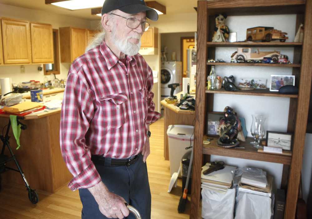 Photo by Kelly Sullivan/ Peninsula Clarion Verne Brown leans on the cane he now needs to support himself after losing a leg after the bus he was driving for Unique Bus Charters carrying 49 students collided with a Department of Transportation semi-truck last year, Friday, June 12, 2015, at his home in Kenai, Alaska