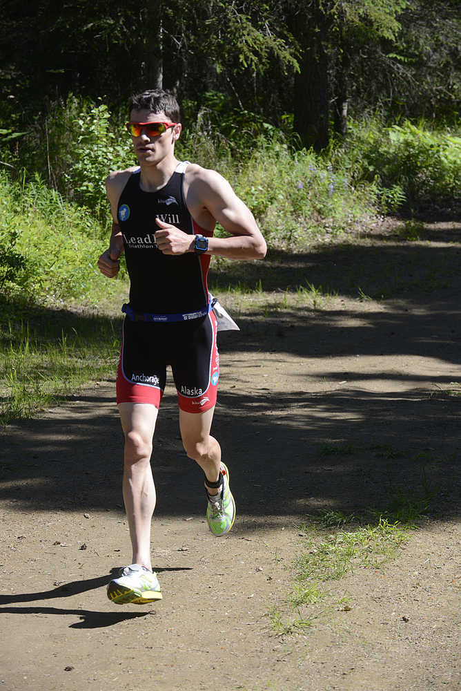 Photo by Rashah McChesney/Peninsula Clarion M. Scott Moon photographs the "MoonCheyEttes" after the final leg of their race on Sunda yJune 14, 2015 at the Tri the Kenai triathlon in Soldotna, Alaska.