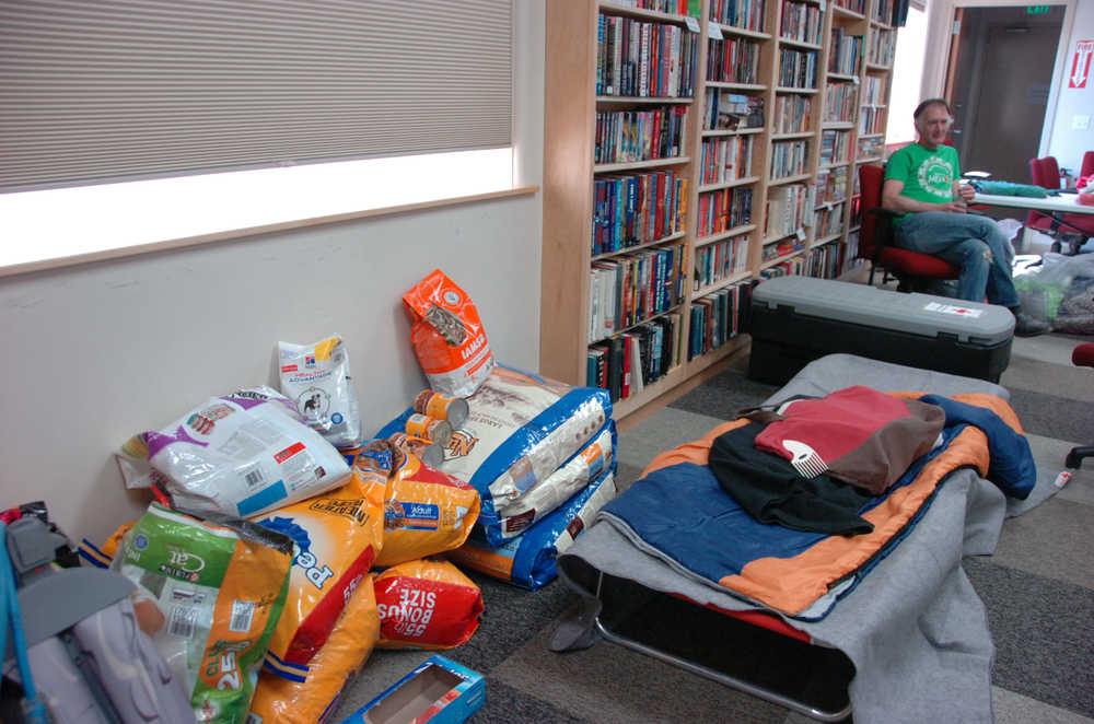 Volunteers brought pet food, blankets, pillows and more to the Sterling Community Center on Tuesday to help those displaced by the Card Street Fire. Photo by Megan Pacer/Peninsula Clarion