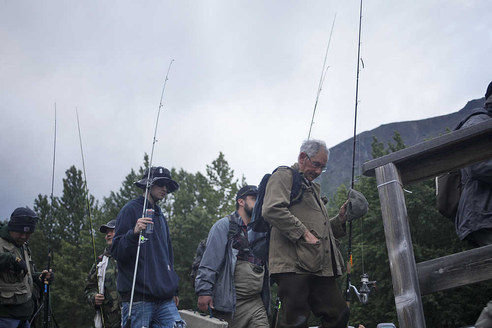 Photo by Rashah McChesney/Peninsula Clarion Anglers wait in line to catch the first ferry of the Russian River opener at 6 a.m. on June 11, 2015 near Cooper Landing, Alaska.